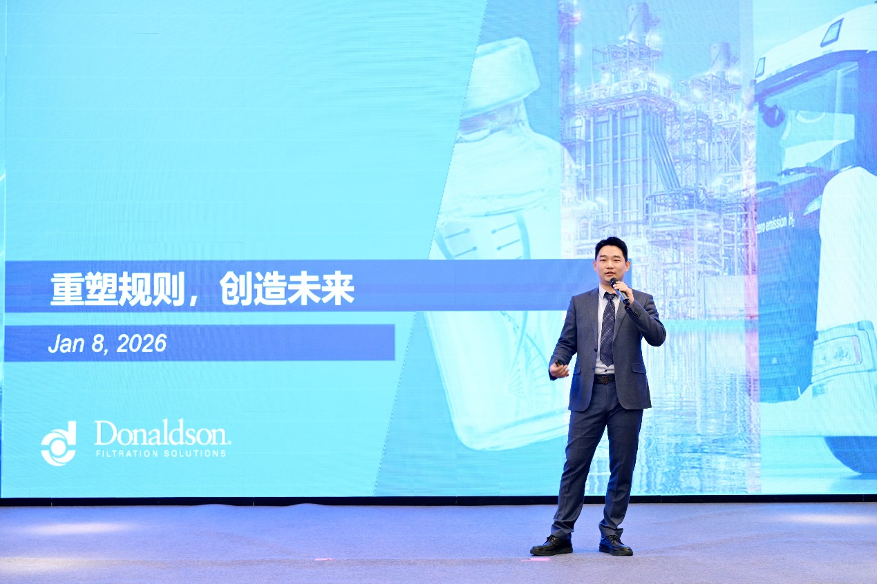 A person in a suit speaking into a microphoneAI-generated content may be incorrect.